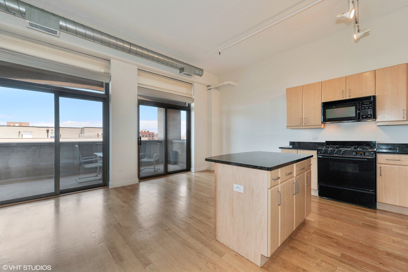 1301 West Madison Street, Unit 506 Chicago, IL 60607 - Photo 4 of 23 a kitchen with granite countertop a stove top oven and sink