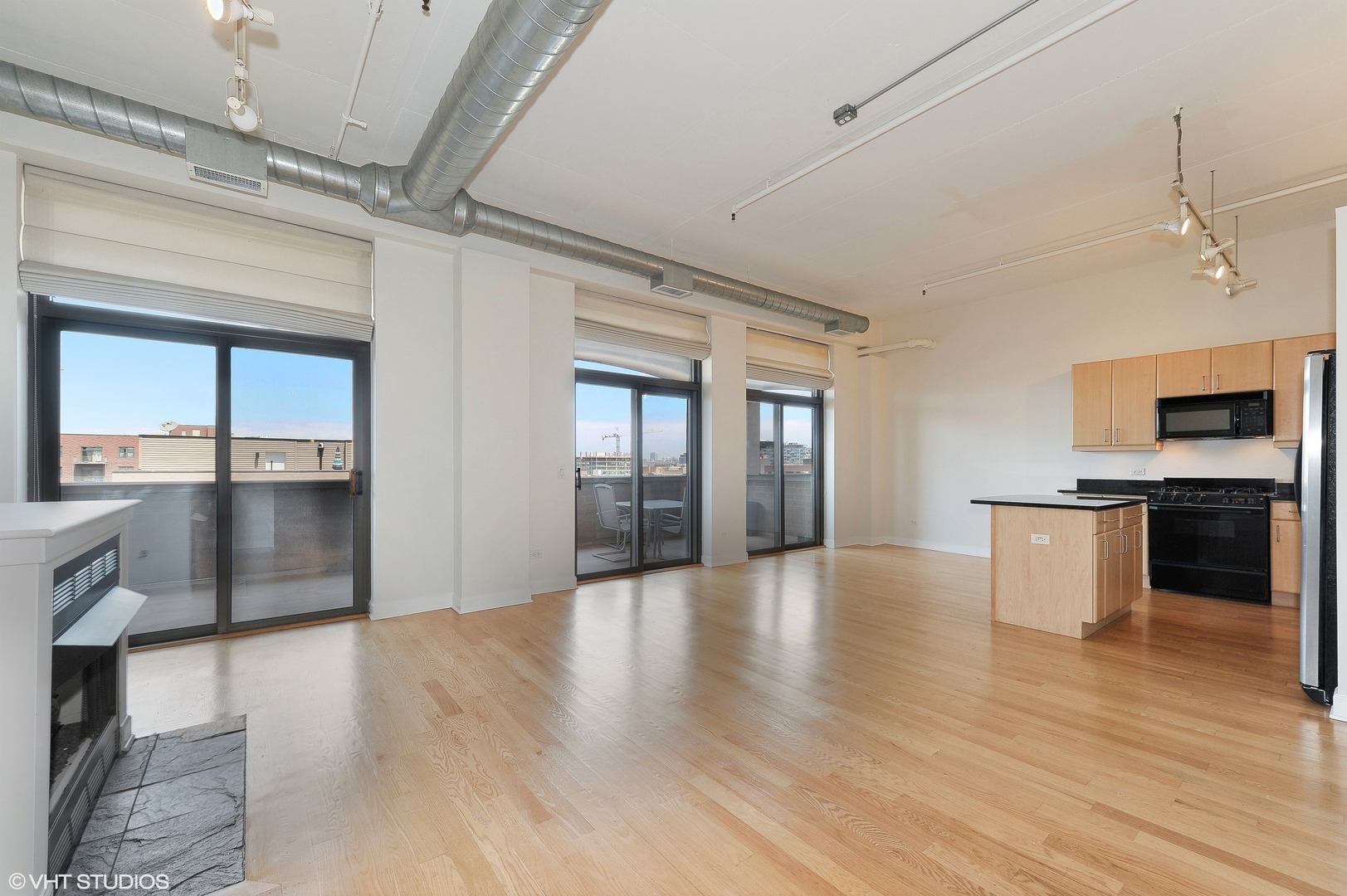 1301 West Madison Street, Unit 506 Chicago, IL 60607 - Photo 6 of 23 a view of an empty room with window and wooden floor