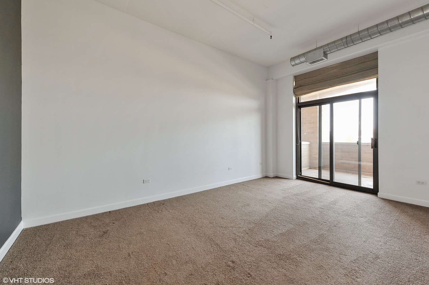 1301 West Madison Street, Unit 506 Chicago, IL 60607 - Photo 8 of 23 an empty room with windows