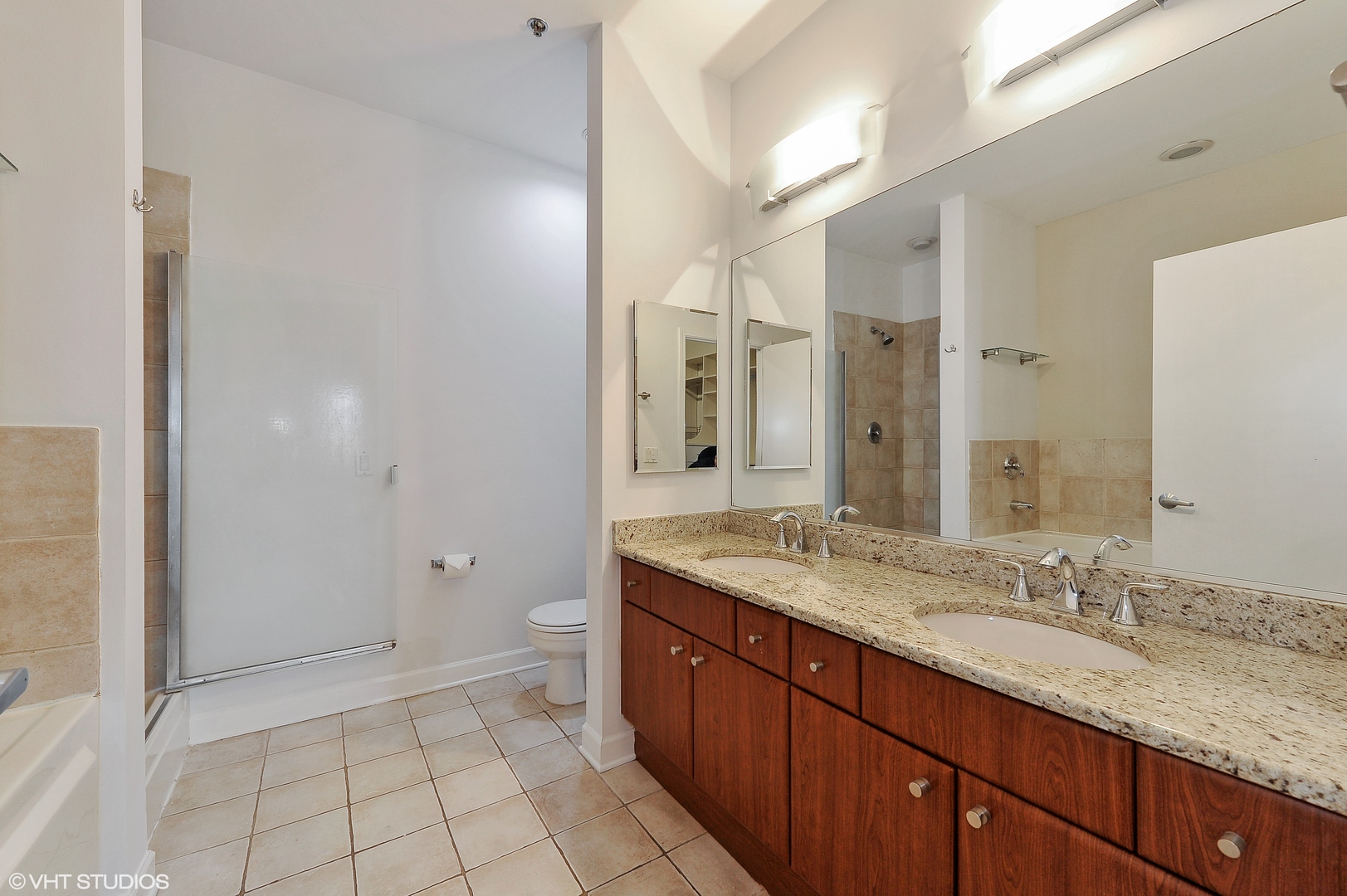 1301 West Madison Street, Unit 506 Chicago, IL 60607 - Photo 9 of 23 a bathroom with a granite countertop sink toilet and shower