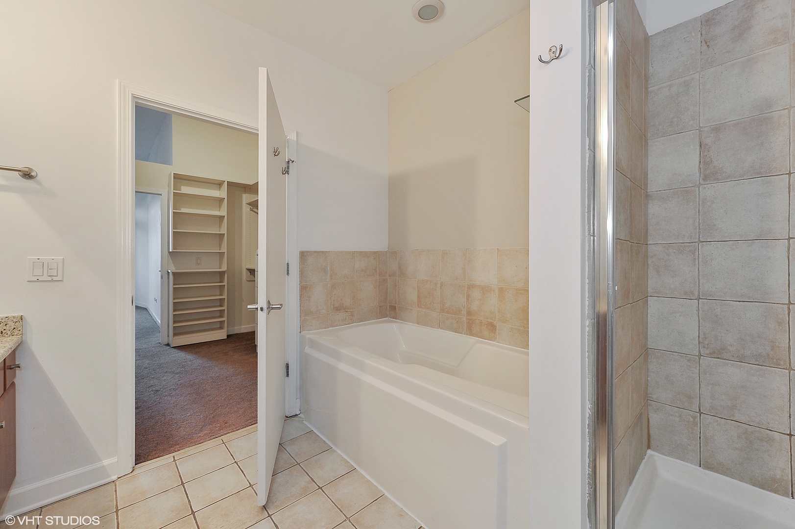 1301 West Madison Street, Unit 506 Chicago, IL 60607 - Photo 10 of 23 a bathroom with a bathtub and a shower