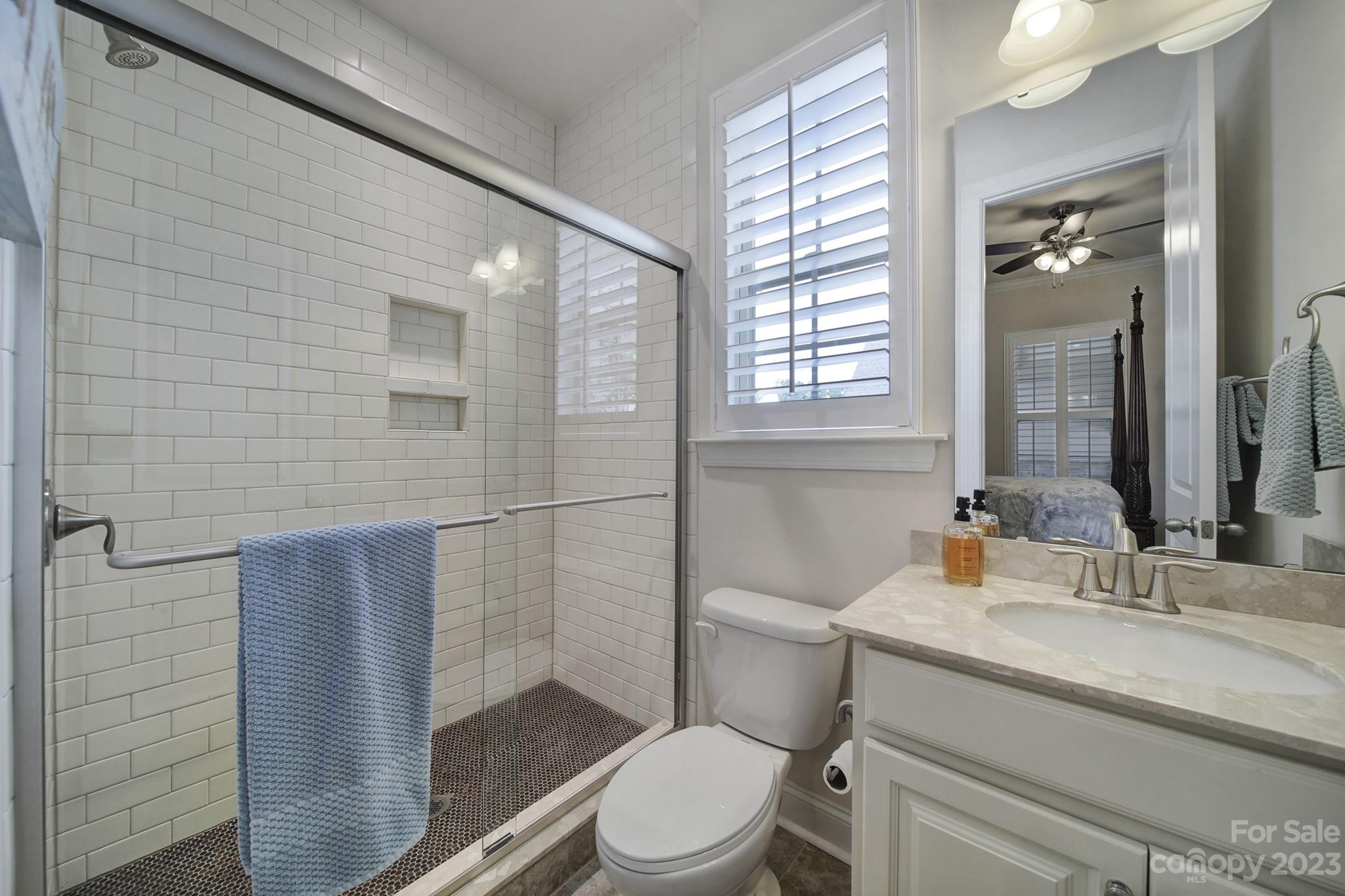 1356 Afton Way Fort Mill, SC 29708 - Photo 29 of 46 a bathroom with a granite countertop toilet a sink and a mirror