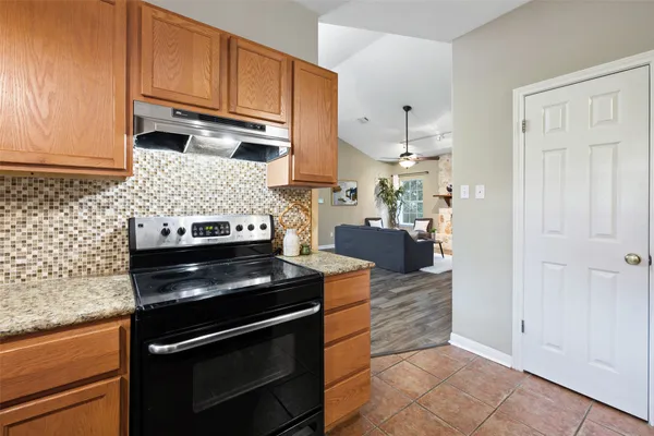 a kitchen with a stove and a refrigerator