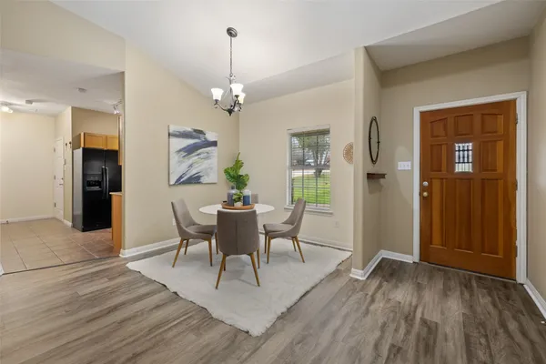 a view of a dining room with furniture and wooden floor