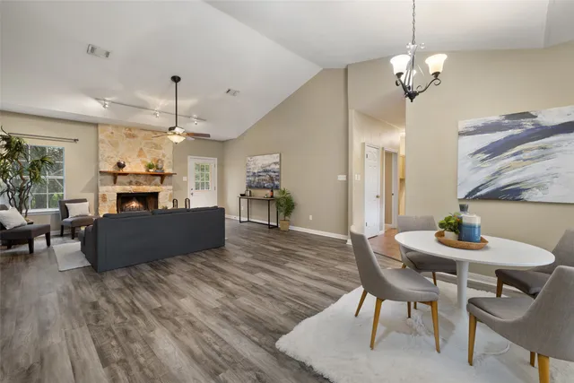 a living room with furniture kitchen view and a chandelier