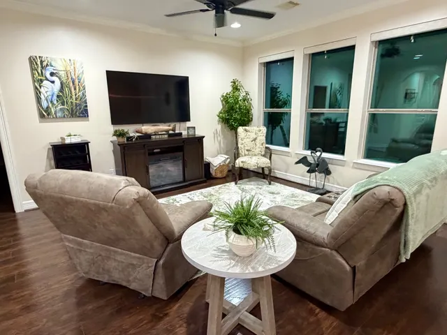 a living room with furniture and a flat screen tv