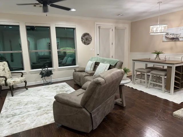 a living room with furniture and wooden floor