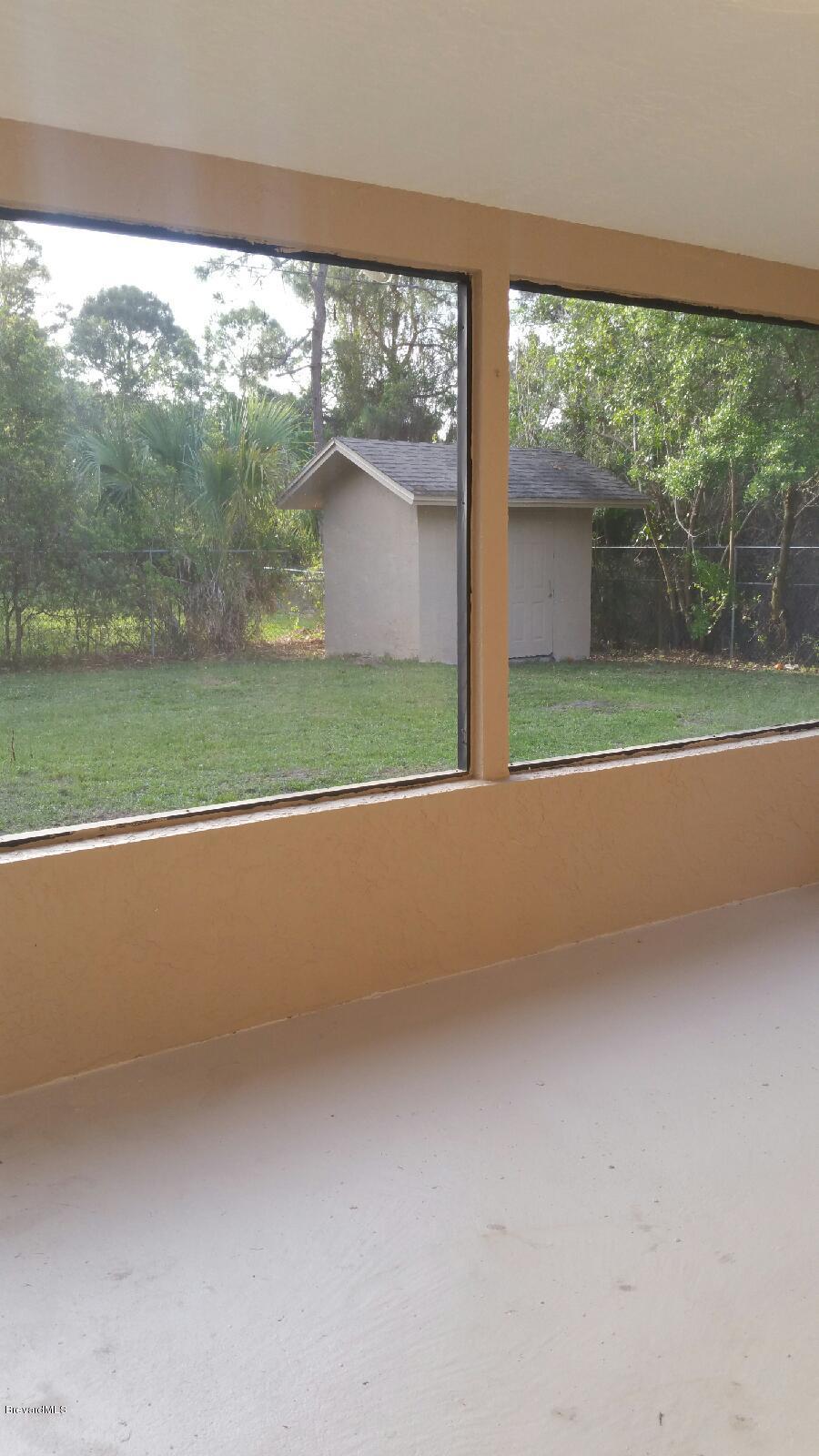 623 Tooley Road Southwest Palm Bay, FL 32908 - Photo 6 of 6 screened patio back yard view fenced