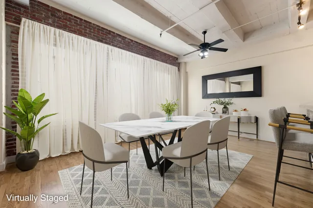 a view of a dining room with furniture and a potted plant