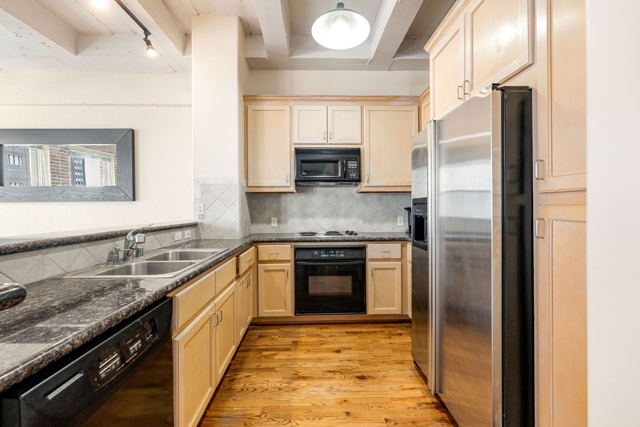 1120 Texas Street, Unit 7D Houston, TX 77002 - Photo 16 of 28 a kitchen with stainless steel appliances granite countertop a refrigerator and a stove