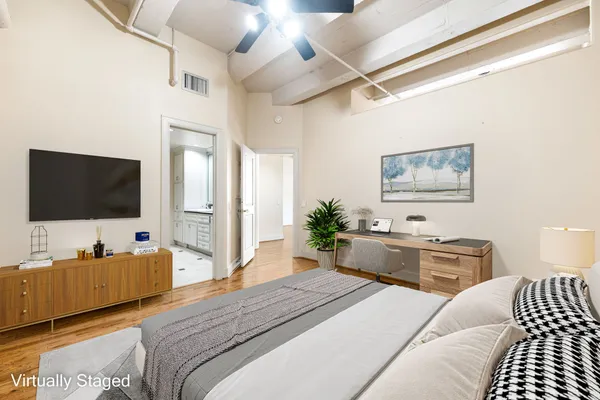 a bedroom with a bed and a flat screen tv