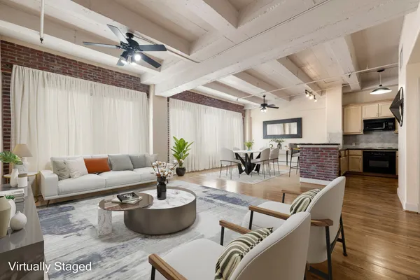 a living room with furniture and a potted plant