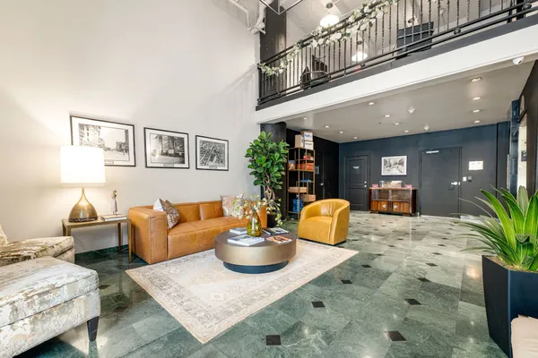 a living room with furniture and flowers