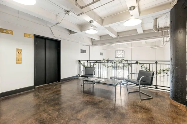 a view of a livingroom with furniture and a floor to ceiling window