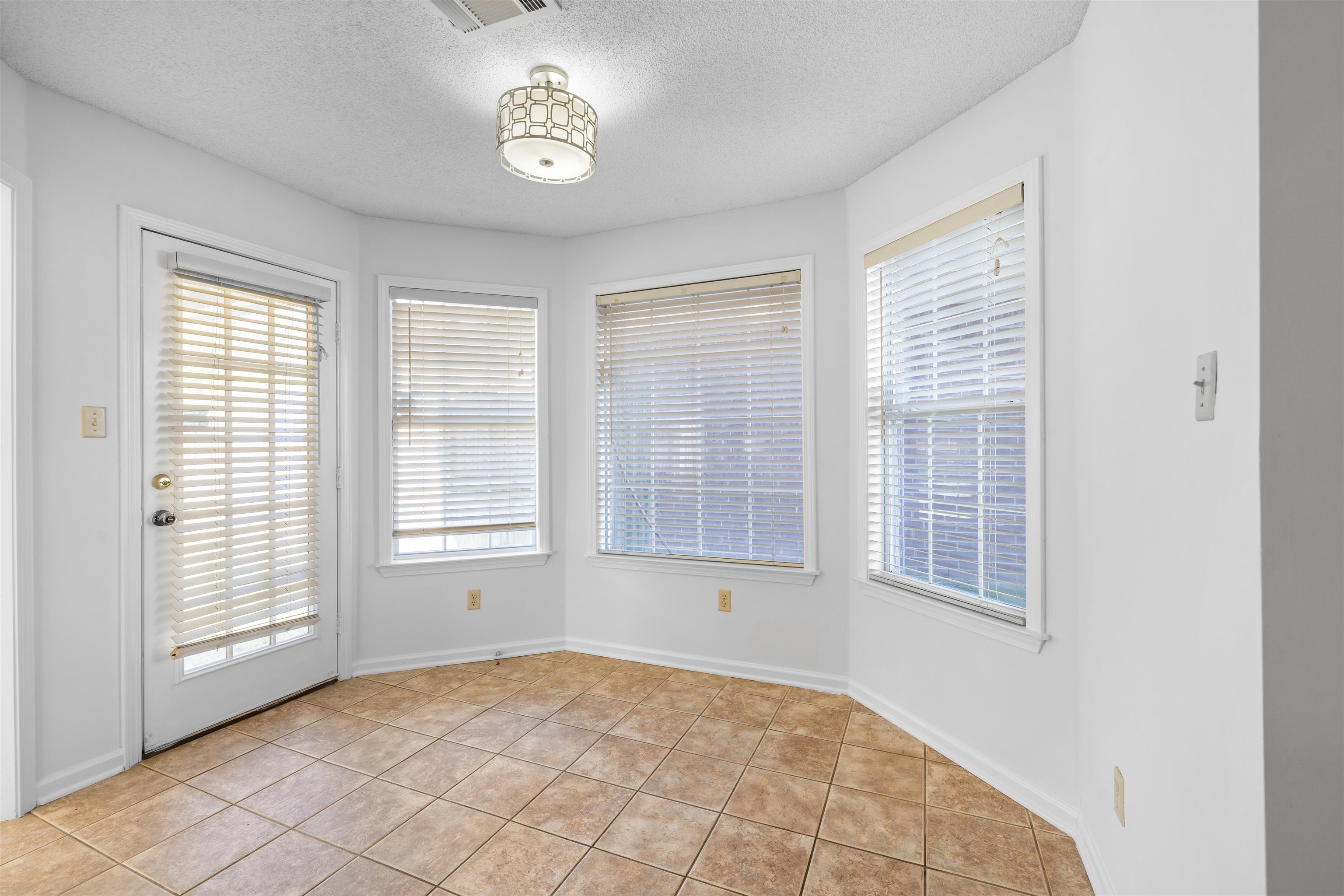7361 Appling Ridge Drive Cordova, TN 38018 - Photo 13 of 31 Unfurnished dining area with a textured ceiling and light tile patterned flooring