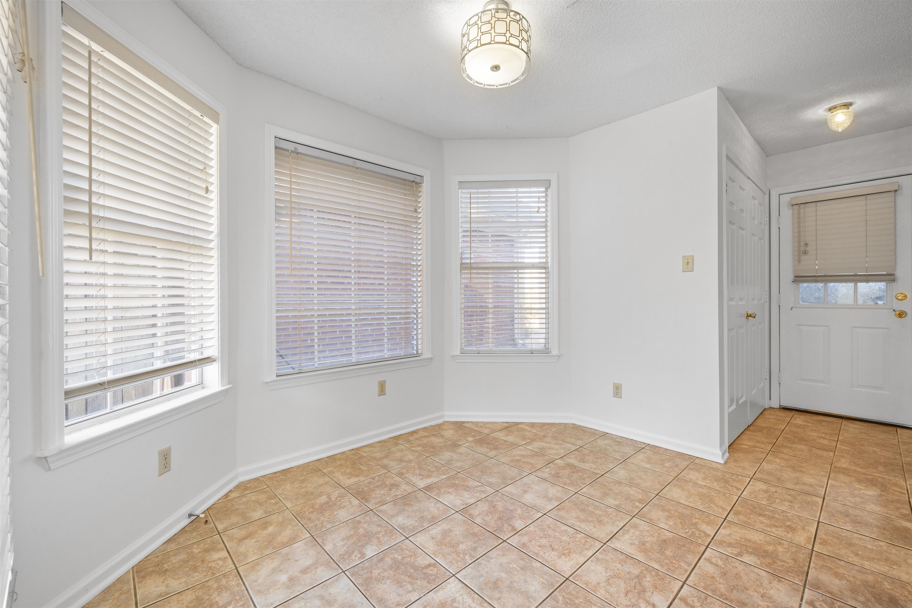 7361 Appling Ridge Drive Cordova, TN 38018 - Photo 14 of 31 Unfurnished dining area with light tile patterned floors and plenty of natural light