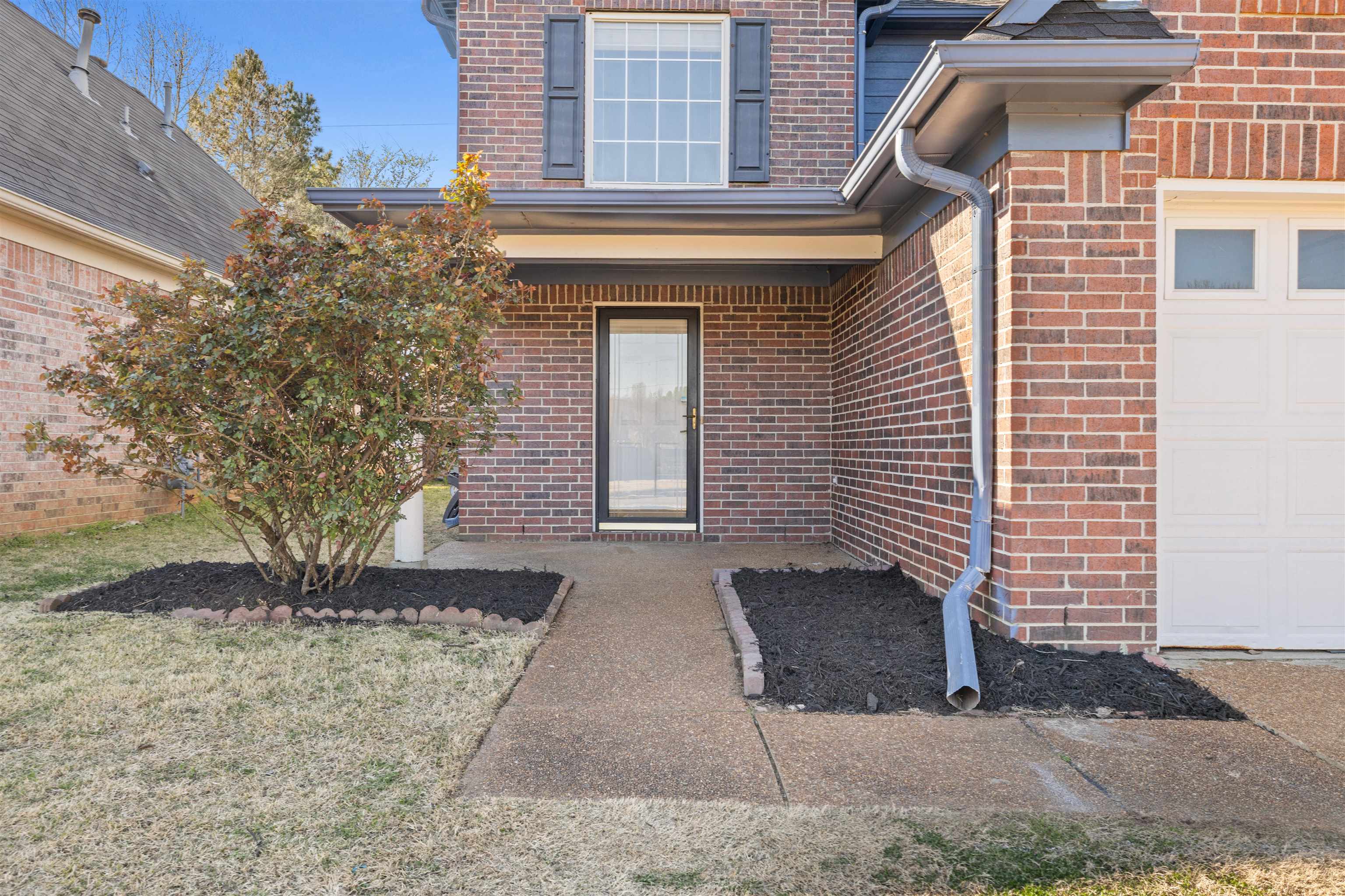 7361 Appling Ridge Drive Cordova, TN 38018 - Photo 3 of 31 Doorway to property with brick siding and a yard