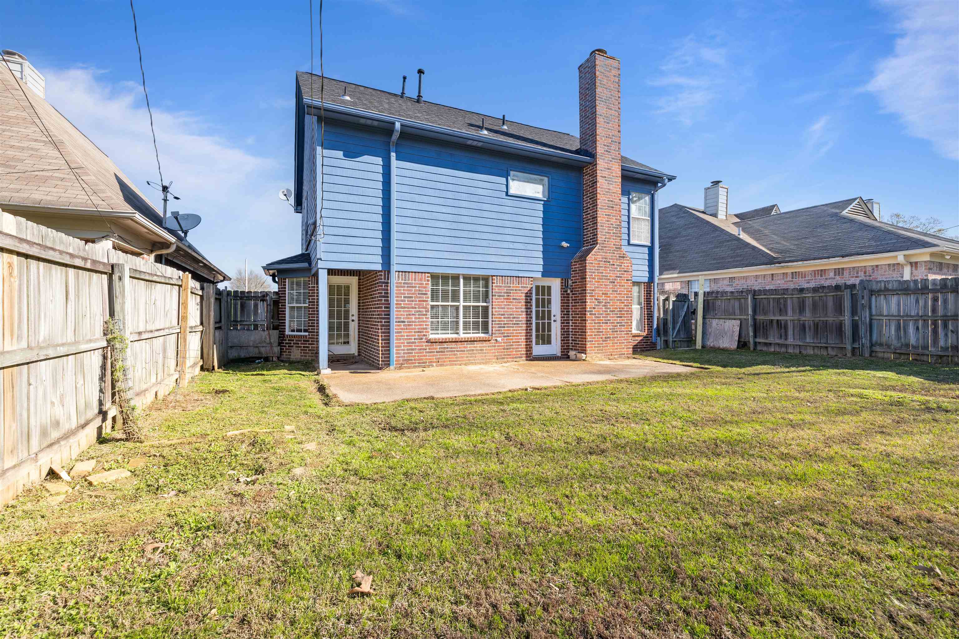 7361 Appling Ridge Drive Cordova, TN 38018 - Photo 31 of 31 Rear view of property featuring brick siding, a chimney, a patio area, and a fenced backyard