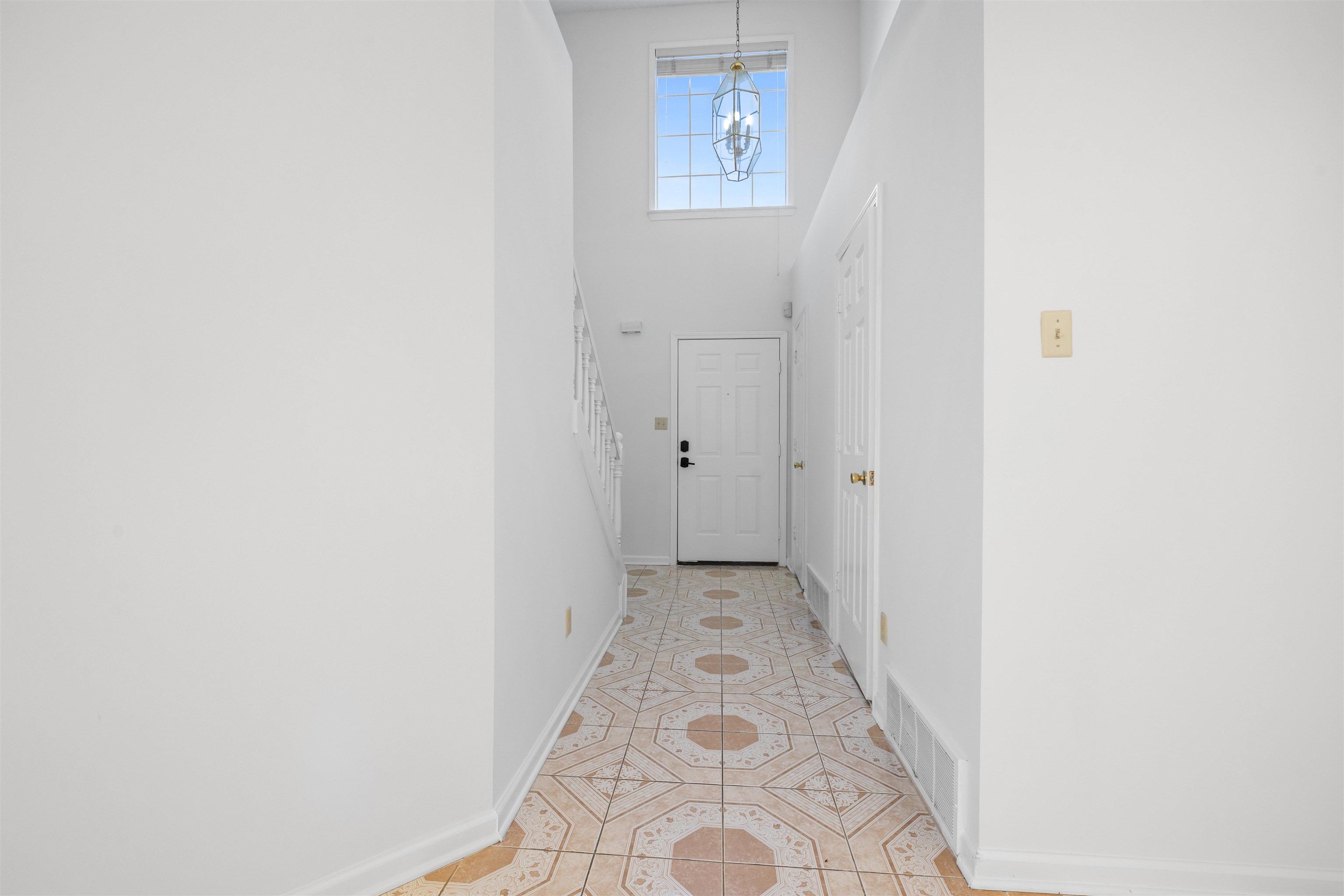 7361 Appling Ridge Drive Cordova, TN 38018 - Photo 8 of 31 Hallway featuring light tile patterned flooring and a high ceiling