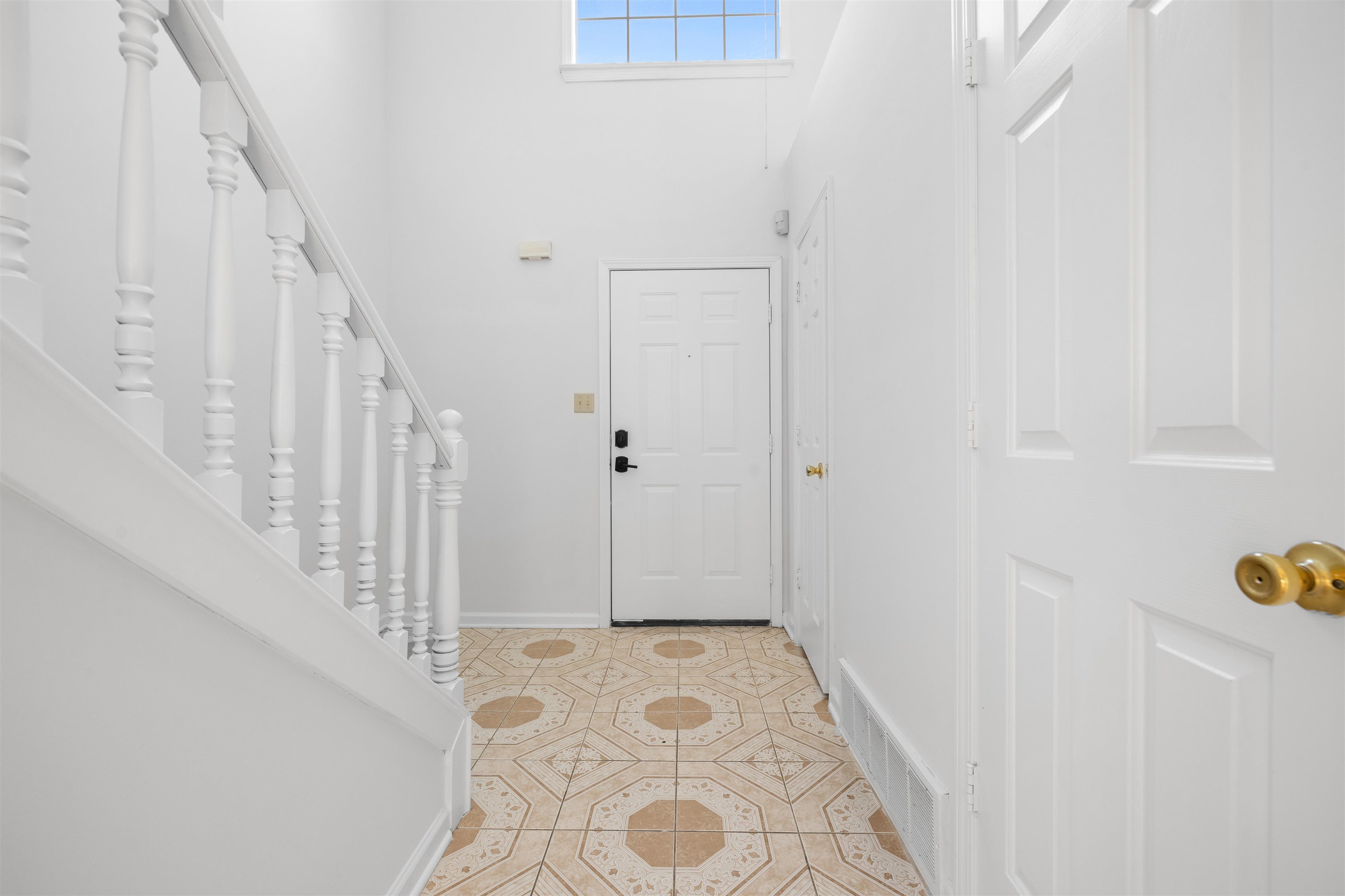 7361 Appling Ridge Drive Cordova, TN 38018 - Photo 9 of 31 Entrance foyer featuring light tile patterned floors and a high ceiling