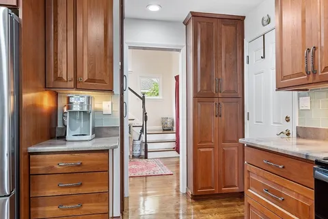a kitchen with stainless steel appliances granite countertop cabinets and a refrigerator