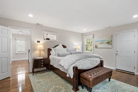 a spacious bedroom with a bed and a couch