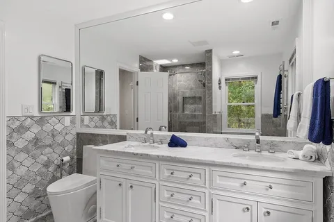 a bathroom with a double vanity sink and a mirror