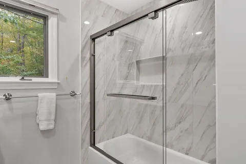 a bathroom with a glass shower door