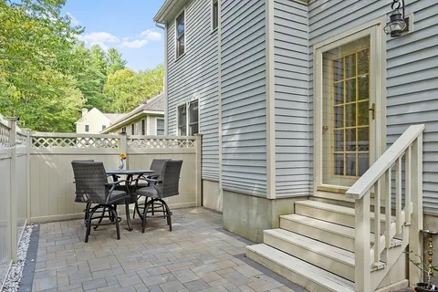 a view of a patio with table and chairs