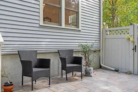 a view of a chair and table in the balcony