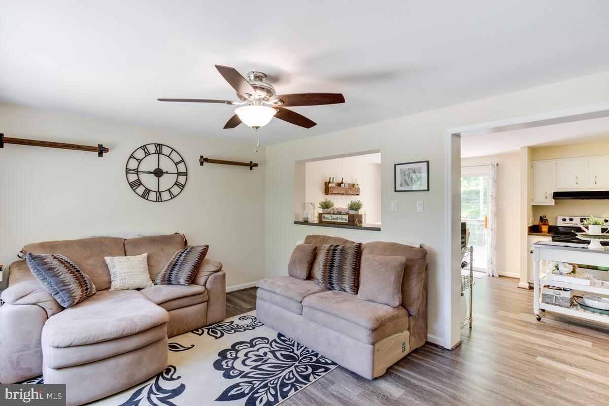 1260 Coster Road Lusby, MD 20657 - Photo 9 of 46 a living room with furniture a couch and a chandelier