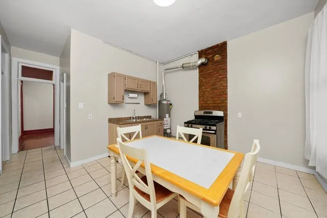 a kitchen with a table chairs and a refrigerator