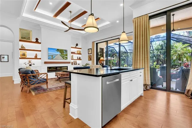 a kitchen with living room and large windows