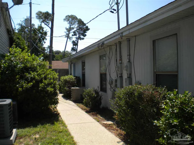 a view of a house with a backyard and garden