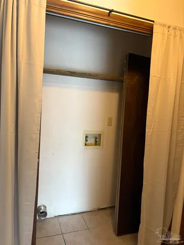 an empty room with a ceiling fan and window