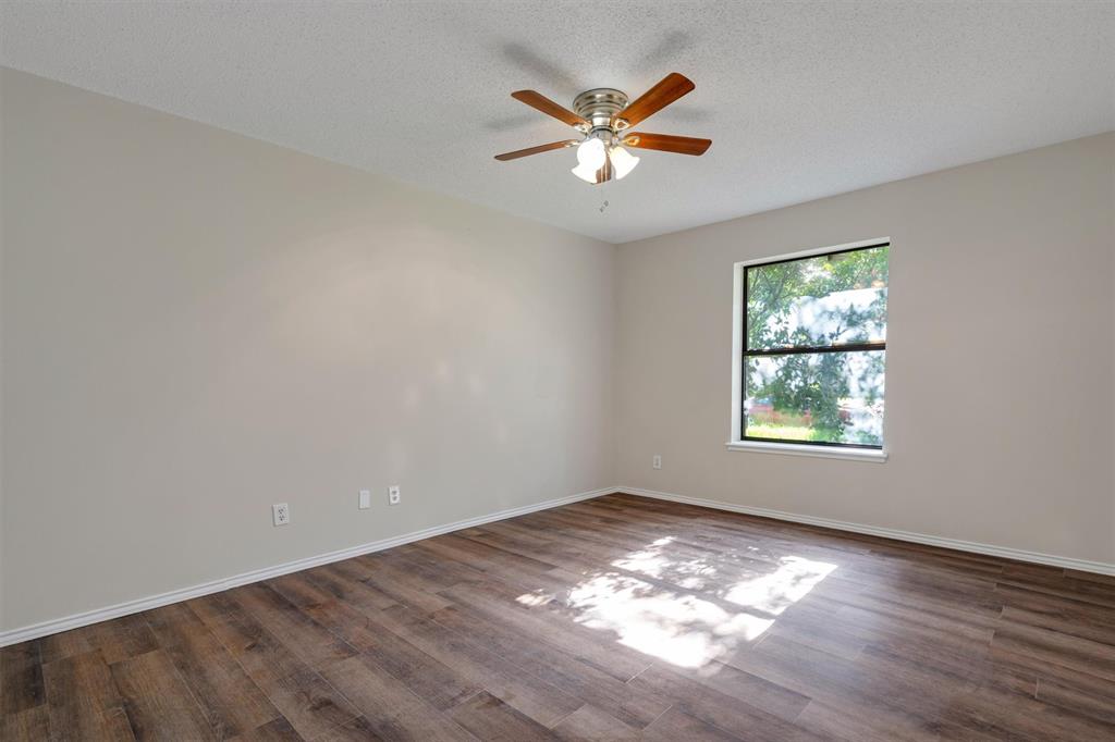 209 Mistletoe Lane Keene, TX 76059 - Photo 28 of 38 an empty room with a window and wooden floor