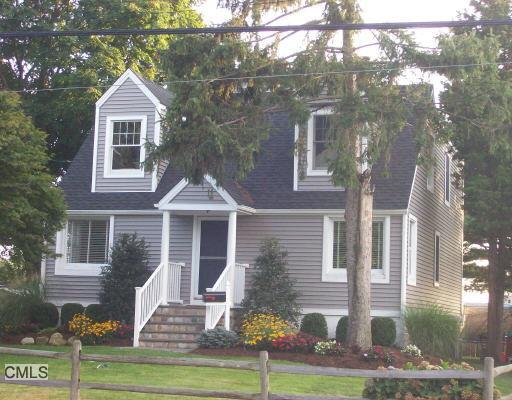 942 Reef Road Fairfield, CT 06824 - Photo 1 of 1 a front view of a house with a yard