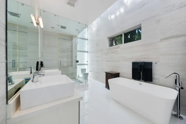 a bathroom with a shower sink and mirror