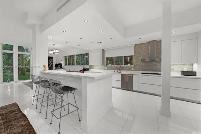 a kitchen with stainless steel appliances kitchen island granite countertop a sink and cabinets