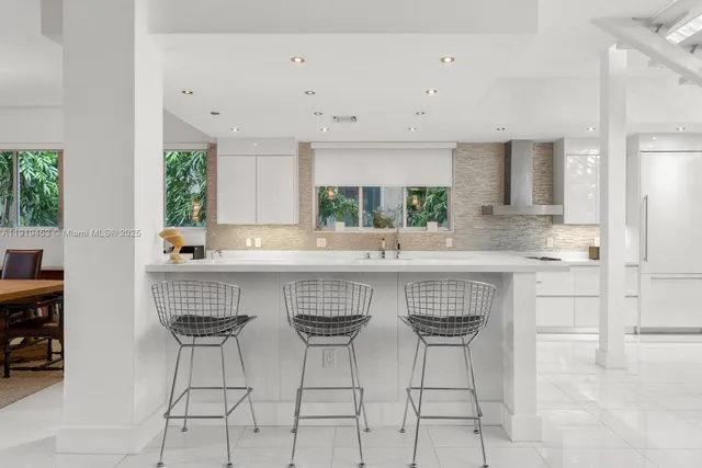 a kitchen with stainless steel appliances a sink and cabinets
