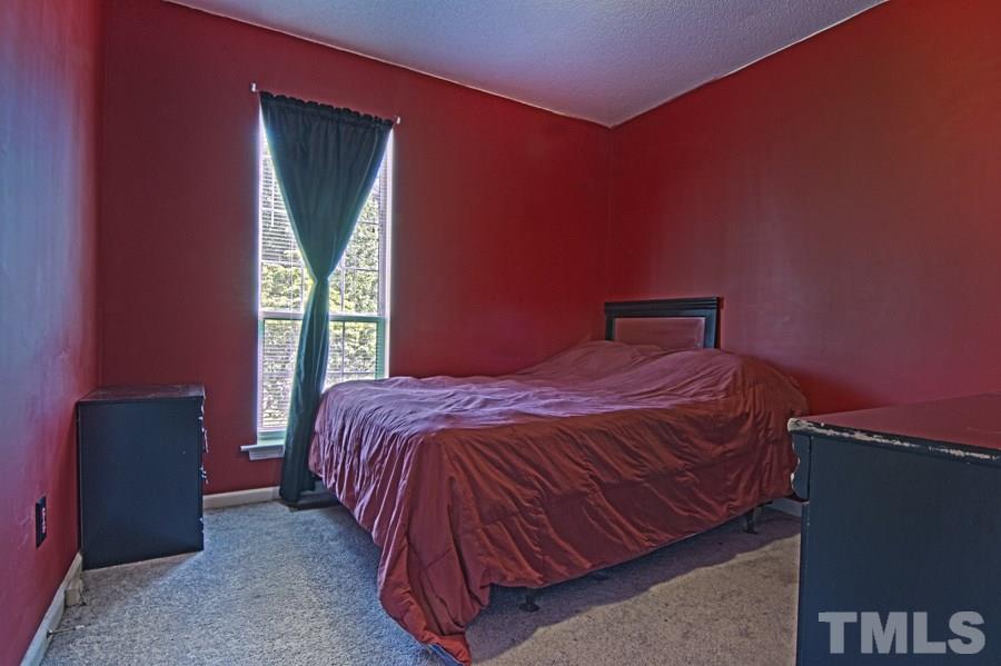 1916 Carthage Circle Raleigh, NC 27604 - Photo 14 of 14 a bed sitting in a bedroom next to a window