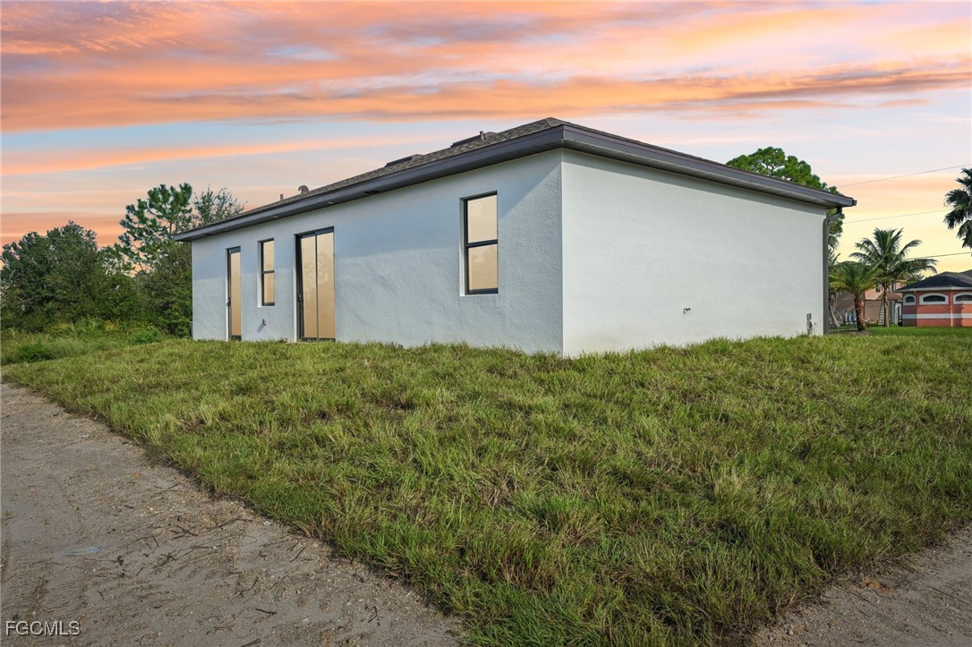 4402 East 19th Street Lehigh Acres, FL 33972 - Photo 13 of 31 a house with green field in front of it
