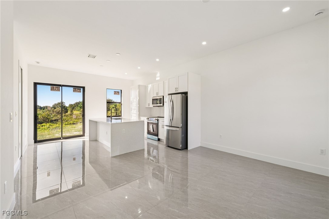 4402 East 19th Street Lehigh Acres, FL 33972 - Photo 17 of 31 a view of kitchen with refrigerator and window