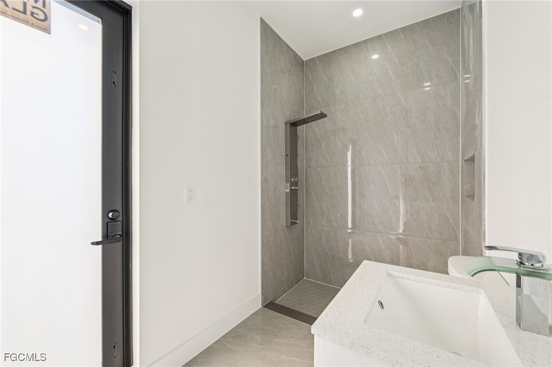 4402 East 19th Street Lehigh Acres, FL 33972 - Photo 30 of 31 a bathroom with a tub and shower