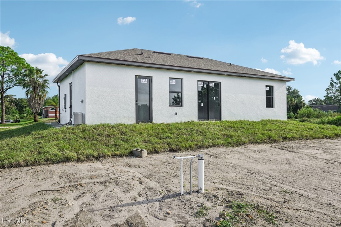 4402 East 19th Street Lehigh Acres, FL 33972 - Photo 7 of 31 a front view of a house with a yard and garage