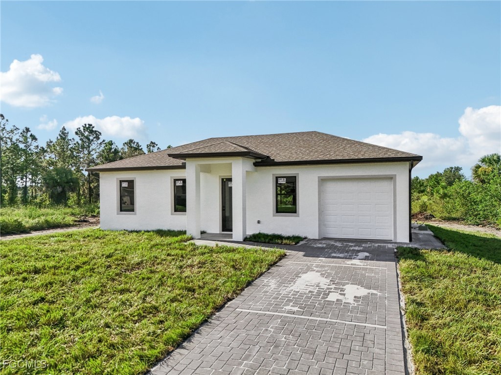4402 East 19th Street Lehigh Acres, FL 33972 - Photo 9 of 31 a view of a house with a yard