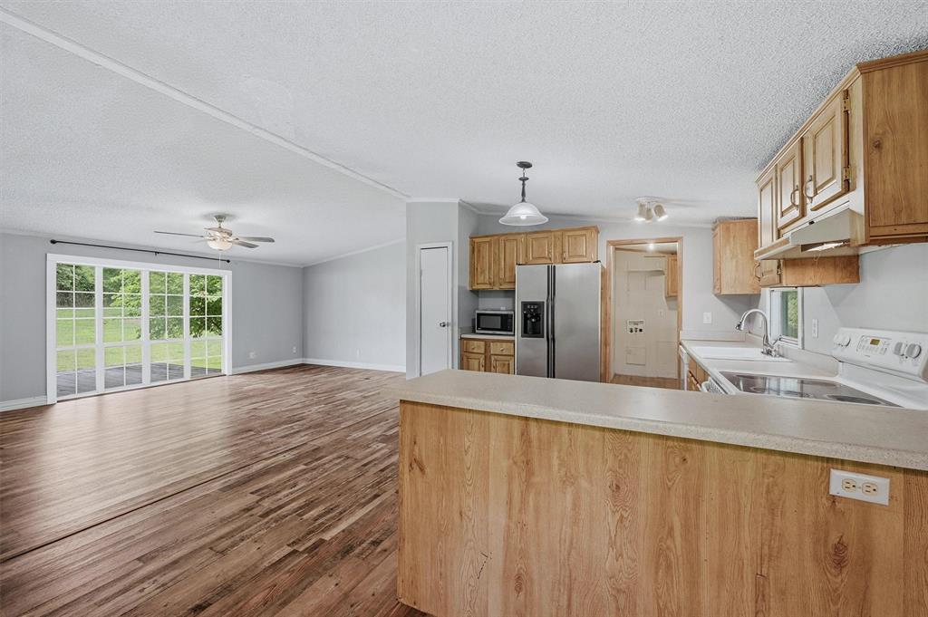 150 Gilbreath Road Sadler, TX 76264 - Photo 12 of 34 a view of a kitchen with a sink and wooden floor