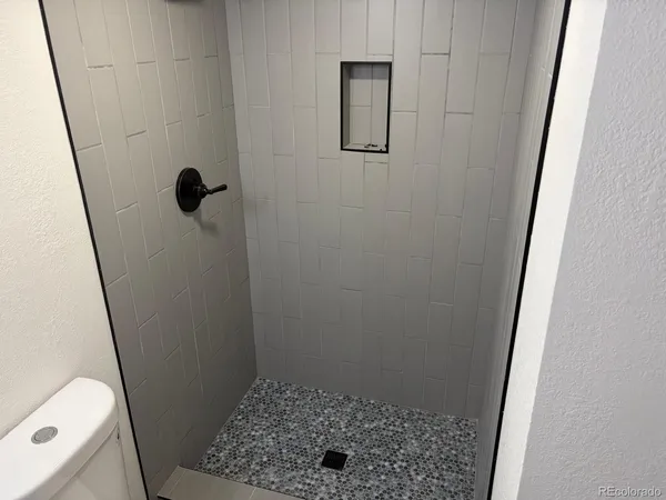 a view of small space with wooden floor and a window