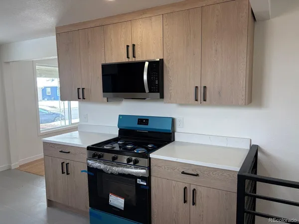 a kitchen with a stove and a microwave