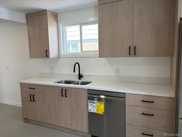 a kitchen with a sink and cabinets